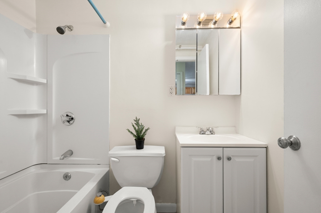 222 Stackpole Street, Unit 4 Lowell, MA 01852 - Photo 11 of 15 a bathroom with a sink toilet and shower
