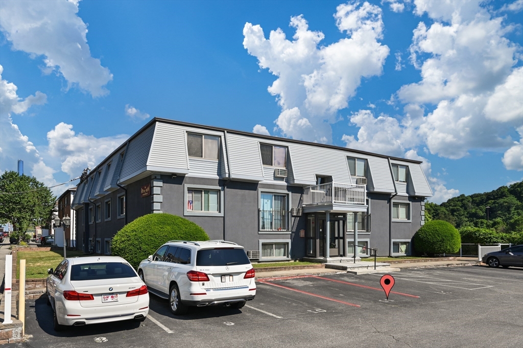 222 Stackpole Street, Unit 4 Lowell, MA 01852 - Photo 15 of 15 a car parked in front of a house