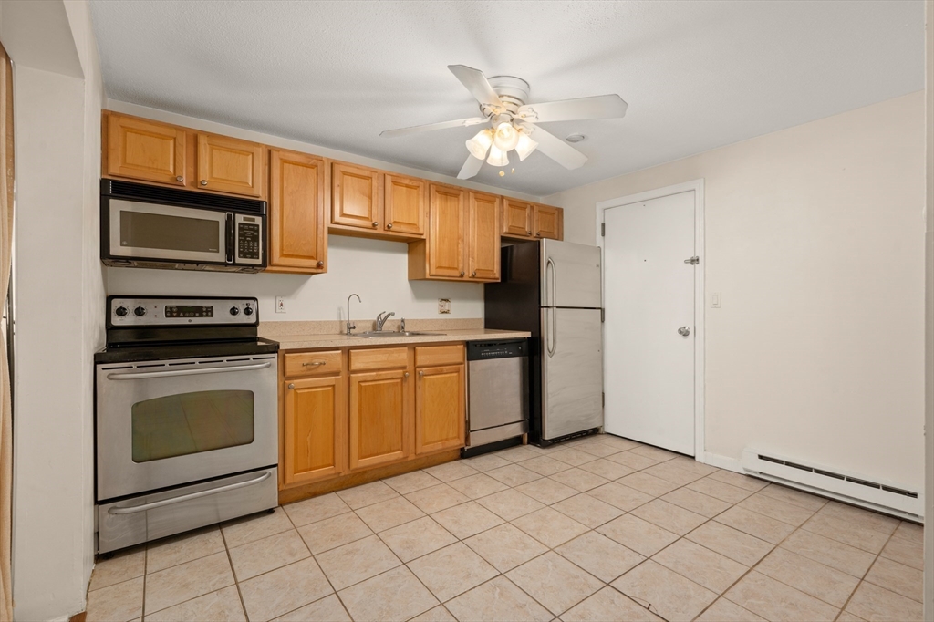 222 Stackpole Street, Unit 4 Lowell, MA 01852 - Photo 5 of 15 a kitchen with stainless steel appliances a stove sink and microwave