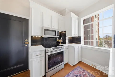 a kitchen with a sink stove top oven and refrigerator