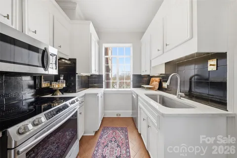 a kitchen that has a sink and a stove