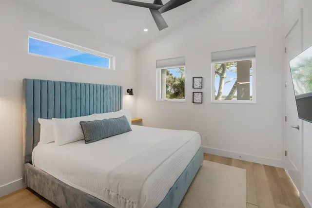 a bedroom with a bed and painting on the wall