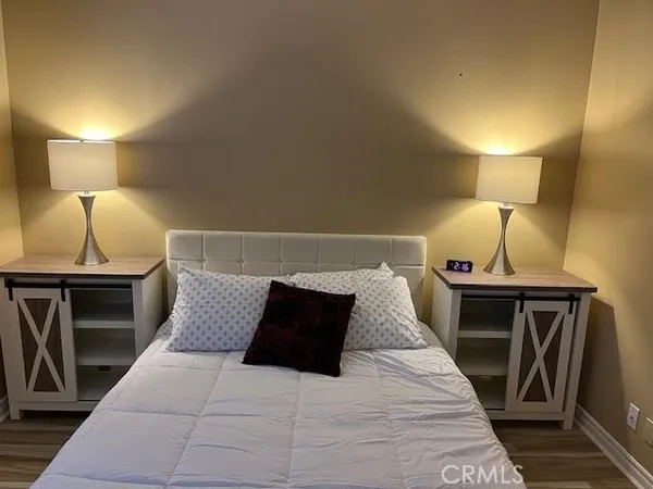 a bed sitting in a bedroom and lamp