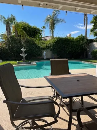 a view of a chairs and table in patio
