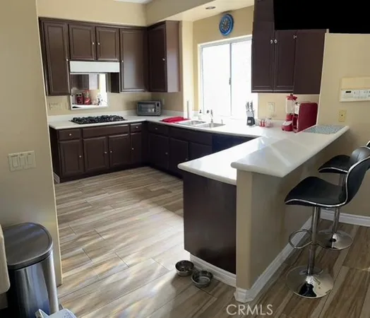 a kitchen with a sink cabinets and wooden floor
