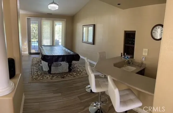 a living room with furniture a window and a flat screen tv