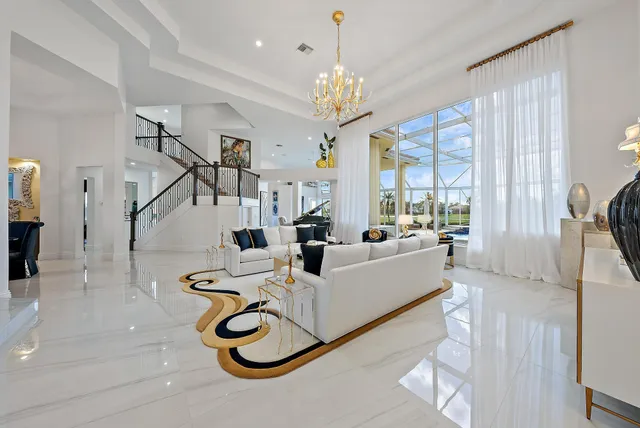 a view of a dining room with furniture one side kitchen view and wooden floor