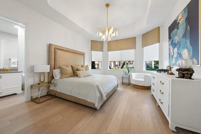 a large white kitchen with a large window