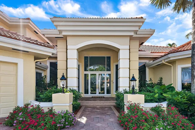 a front view of a house with plants