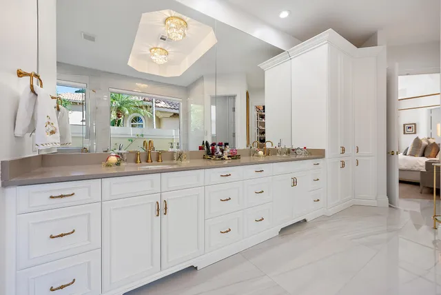 a kitchen with stainless steel appliances kitchen island granite countertop a table and chairs in it