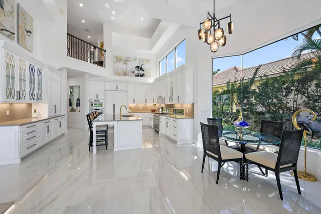 a living room with furniture large window and flat screen tv