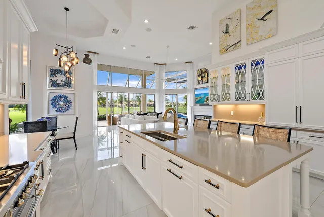 a living room with lots of furniture and kitchen view
