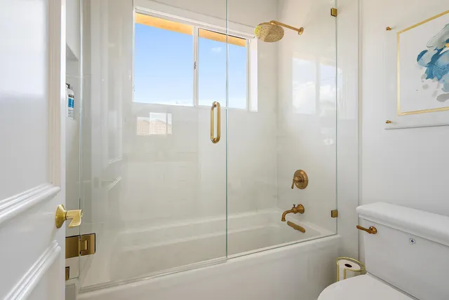 a patio with a table and chairs and potted plants
