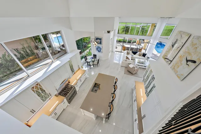 a dining room with furniture a chandelier and window