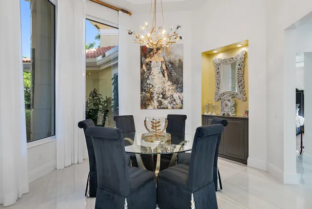 a view of a dining room with furniture a chandelier and wooden floor