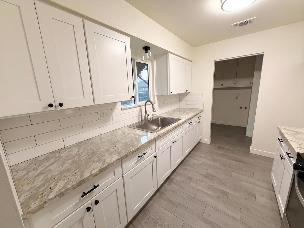302 Sequoia Drive Exeter, CA 93221 - Photo 9 of 20 a spacious bathroom with a granite countertop sink and mirror