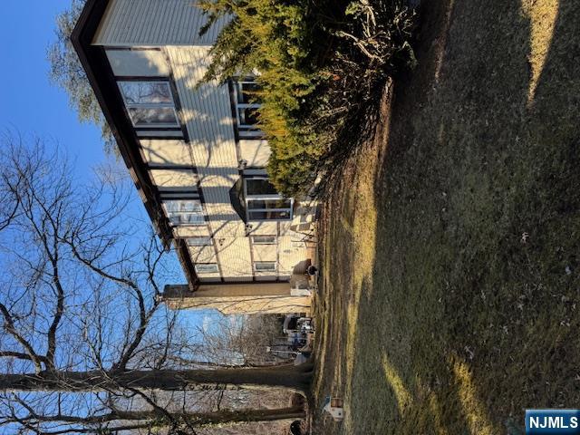 212 Filippe Court Paramus, NJ 07652 - Photo 3 of 16 a front view of a house with a yard