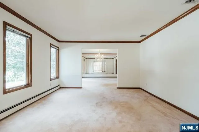 an empty room with windows and closet