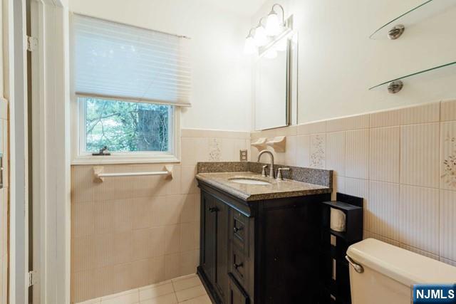 212 Filippe Court Paramus, NJ 07652 - Photo 10 of 16 a bathroom with a granite countertop sink toilet and mirror