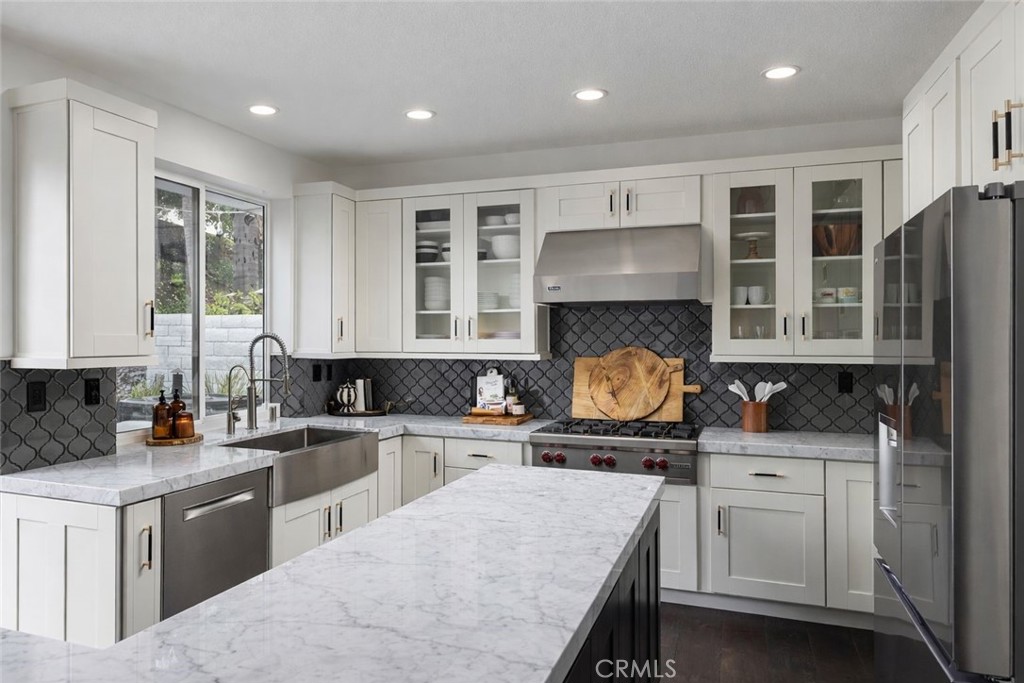 27871 Country Lane Road Laguna Niguel, CA 92677 - Photo 7 of 35 a kitchen with stainless steel appliances granite countertop a stove a sink and a microwave