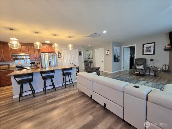 a living room with furniture and a dining table with kitchen view