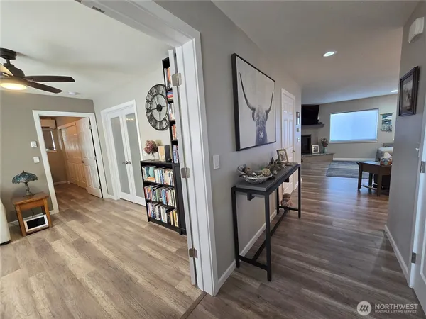 a view of a kitchen with furniture and wooden floor