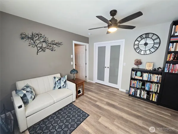 a living room with furniture and a book shelf