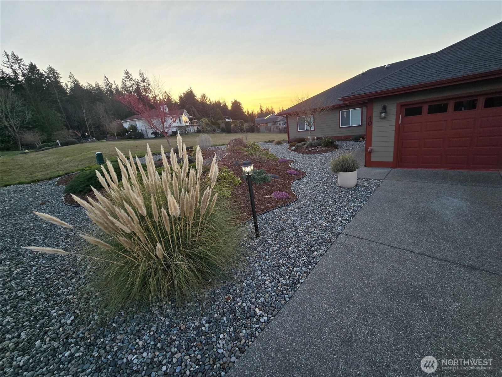 40 Topaz Way Sequim, WA 98382 - Photo 9 of 40 a view of a backyard with plants and a bench