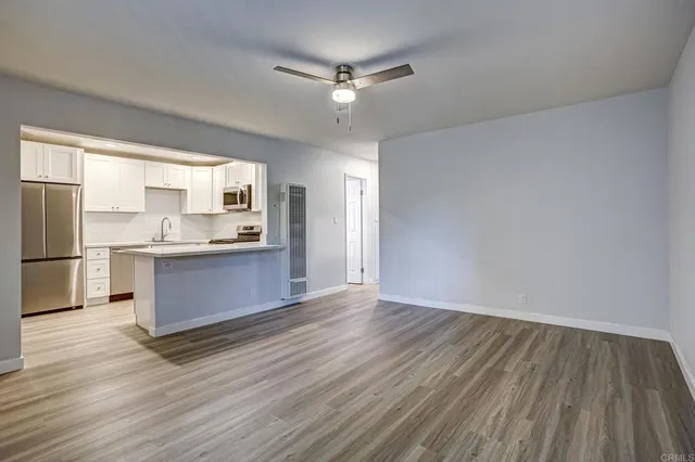 a kitchen with stainless steel appliances a refrigerator and a stove top oven
