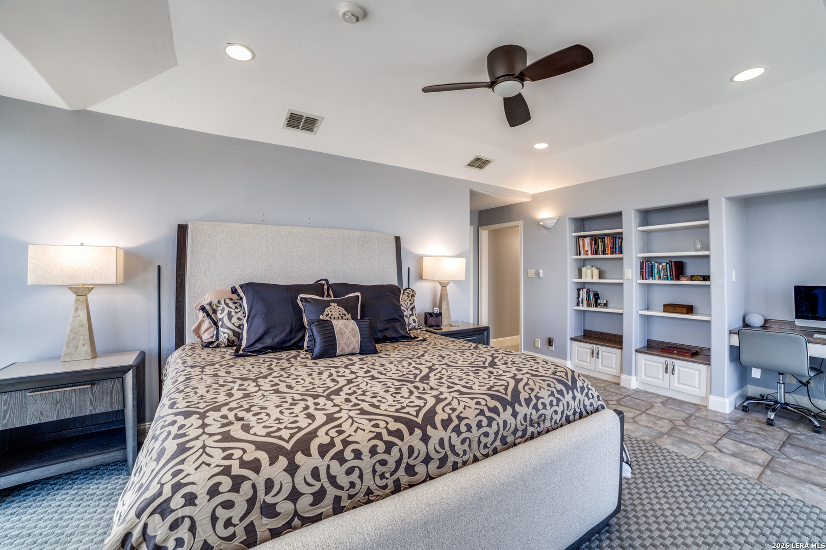 7701 Wurzbach Road, Unit 2303 San Antonio, TX 78229 - Photo 15 of 32 a bedroom with a large bed and a chandelier