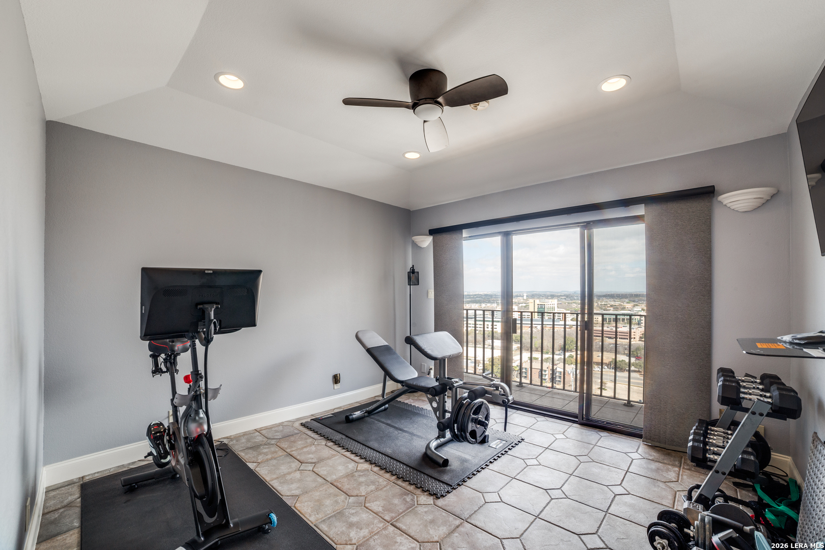 7701 Wurzbach Road, Unit 2303 San Antonio, TX 78229 - Photo 19 of 32 a living room with furniture gym equipment and a large window