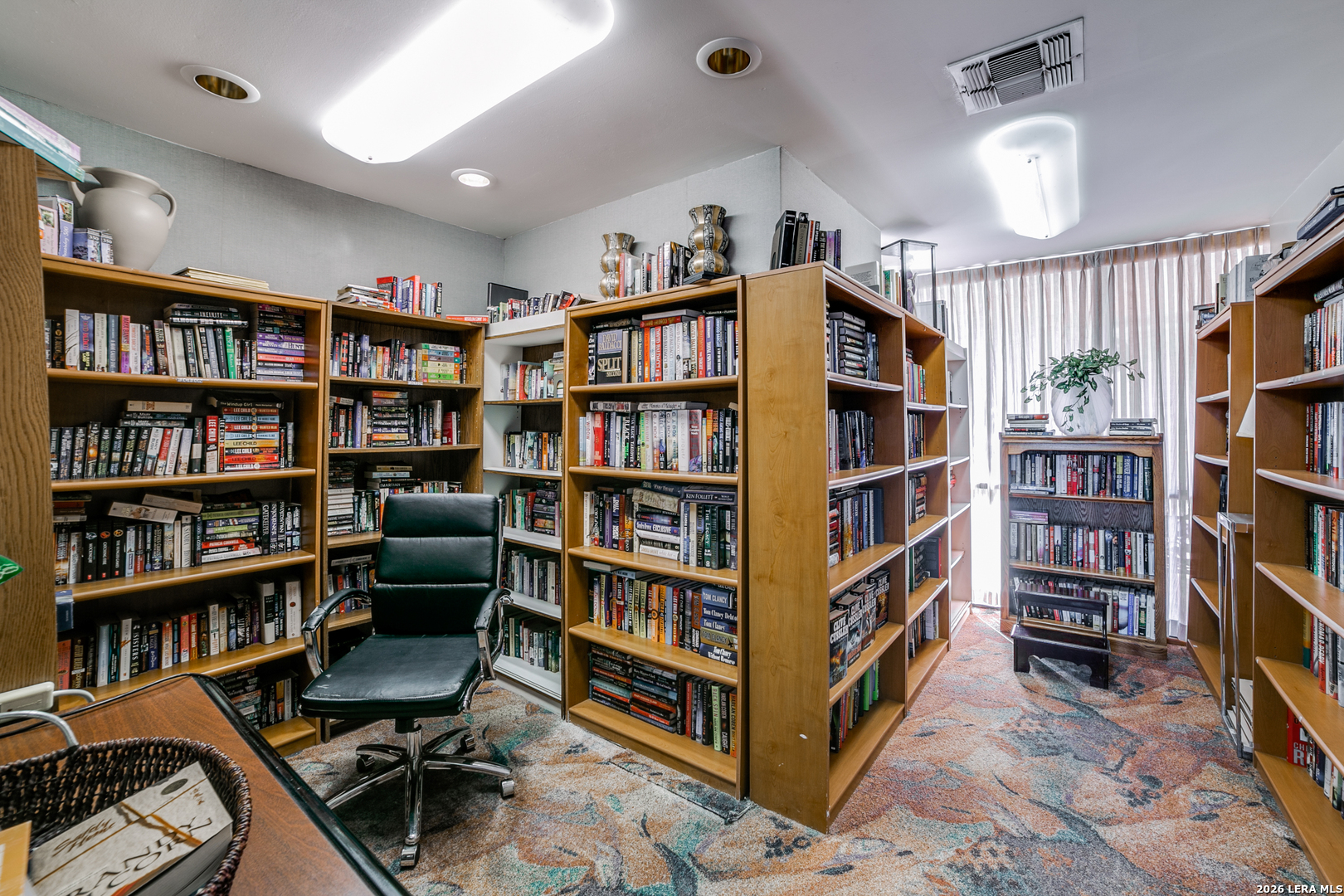 7701 Wurzbach Road, Unit 2303 San Antonio, TX 78229 - Photo 26 of 32 a view of a workspace with bookshelf