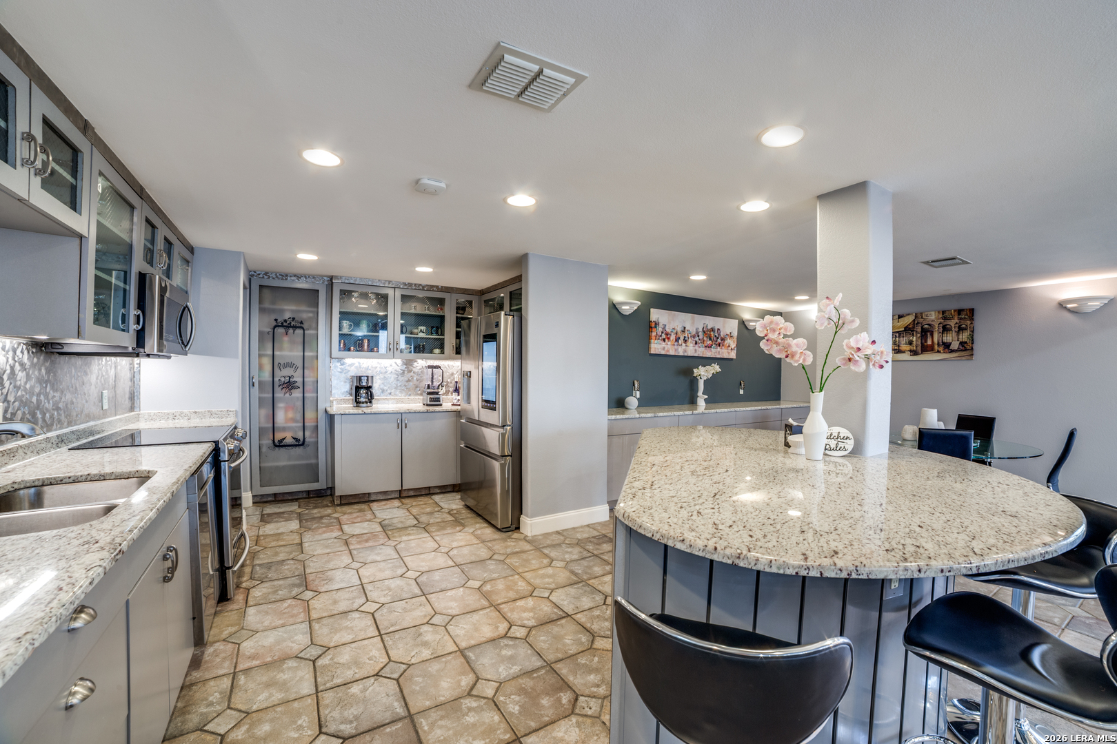 7701 Wurzbach Road, Unit 2303 San Antonio, TX 78229 - Photo 8 of 32 a kitchen with stainless steel appliances granite countertop a stove a sink a microwave a refrigerator and cabinets