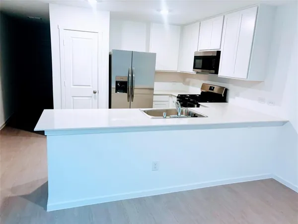 a kitchen with stainless steel appliances a refrigerator and a stove