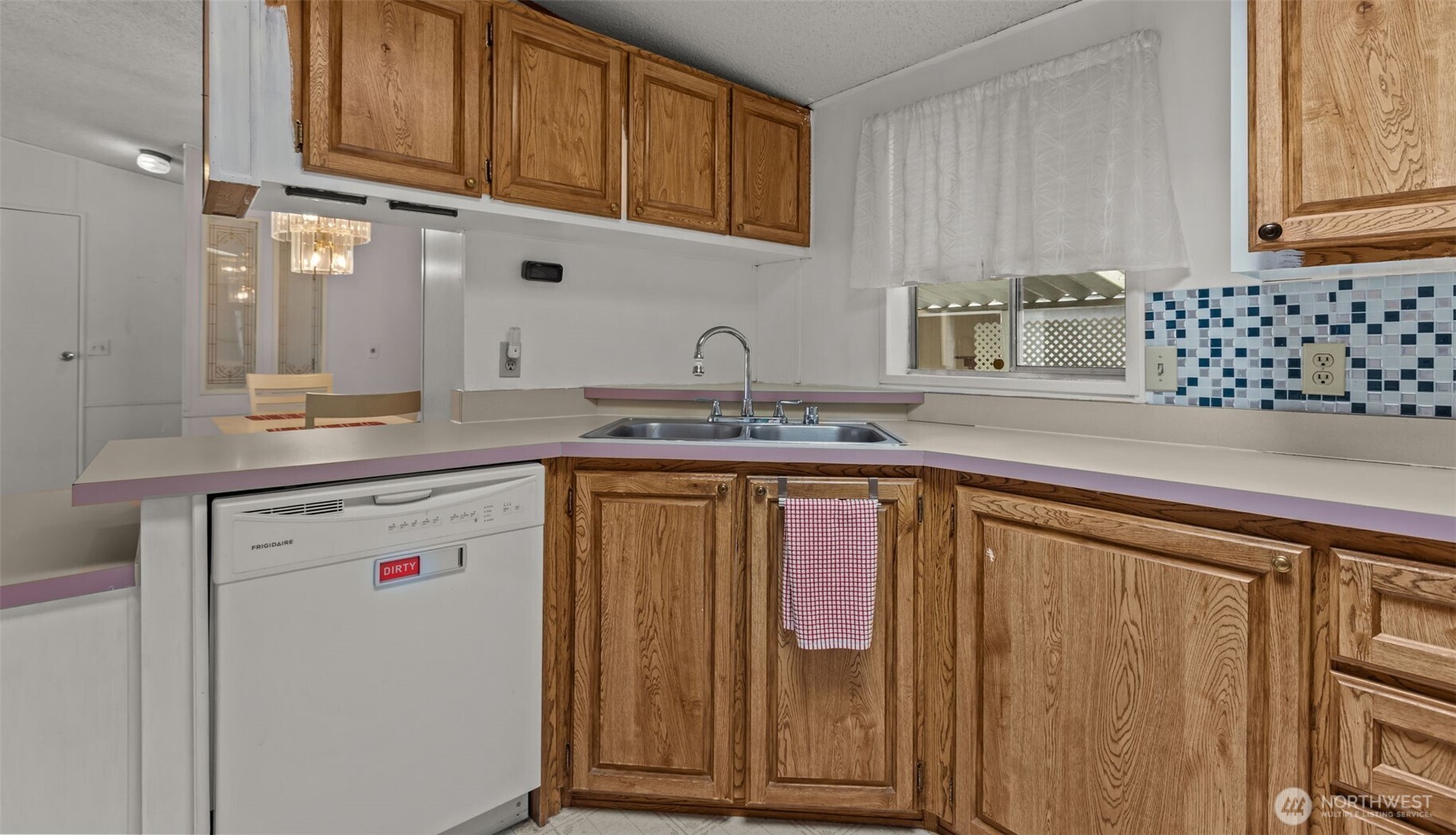 20750 113th Place Southeast Kent, WA 98031 - Photo 12 of 38 a kitchen with stainless steel appliances granite countertop a sink and cabinets with wooden floor