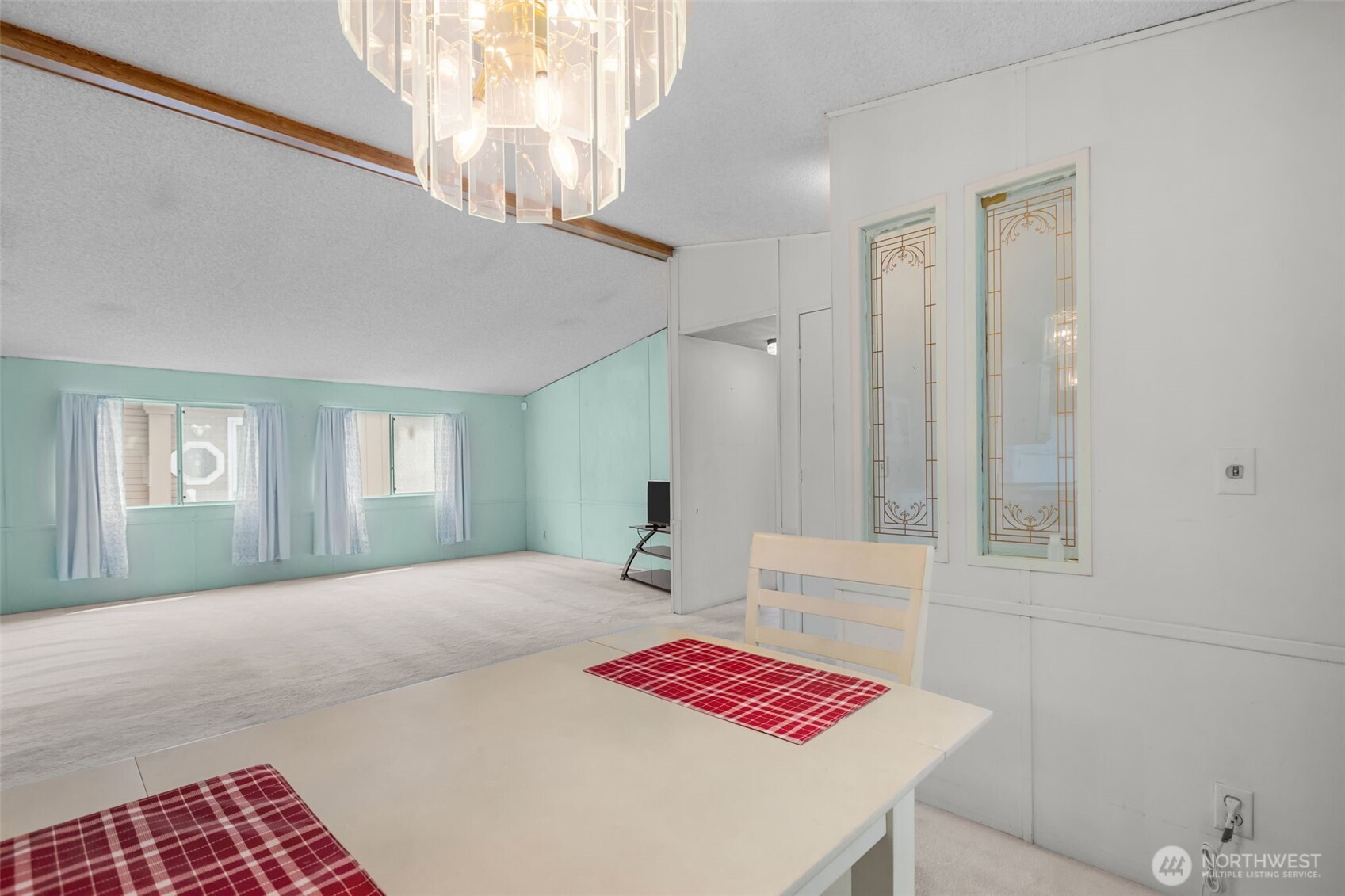 20750 113th Place Southeast Kent, WA 98031 - Photo 8 of 38 a bedroom with a bed and a chandelier