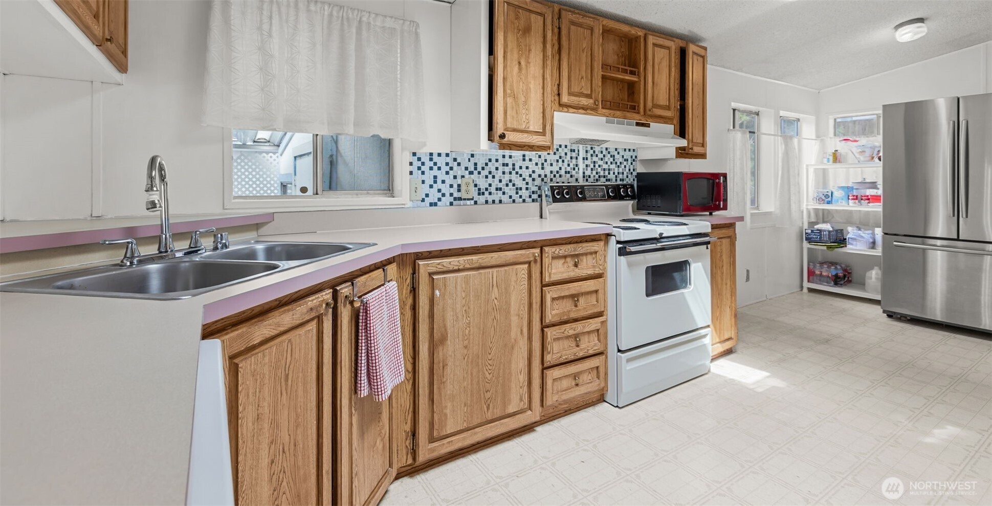 20750 113th Place Southeast Kent, WA 98031 - Photo 10 of 38 a kitchen with a sink stove and refrigerator