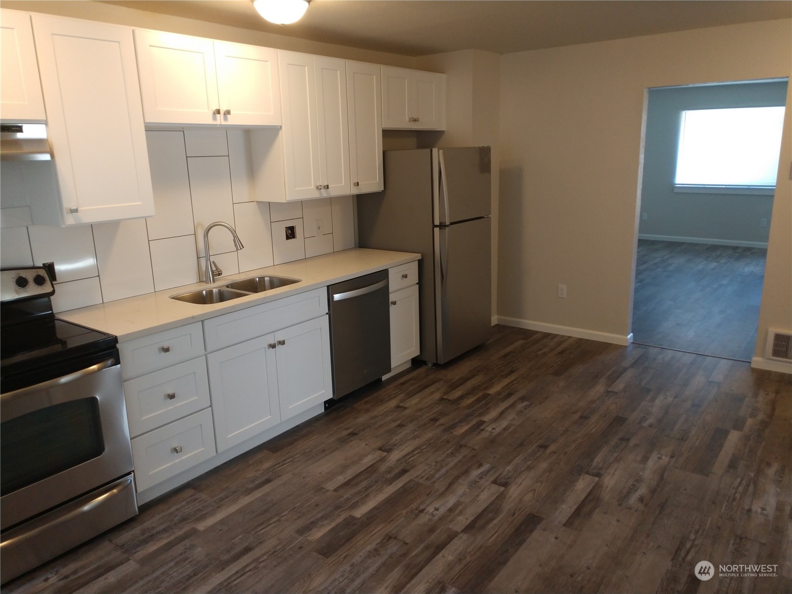 1902 Rockefeller Avenue Everett, WA 98201 - Photo 11 of 17 a kitchen with a sink a refrigerator and cabinets