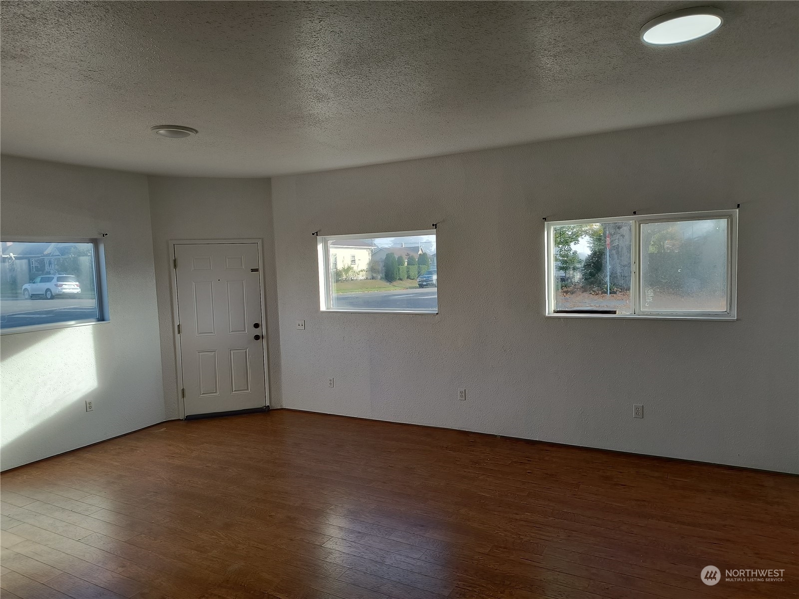 1902 Rockefeller Avenue Everett, WA 98201 - Photo 7 of 17 a view of an empty room with wooden floor and a window
