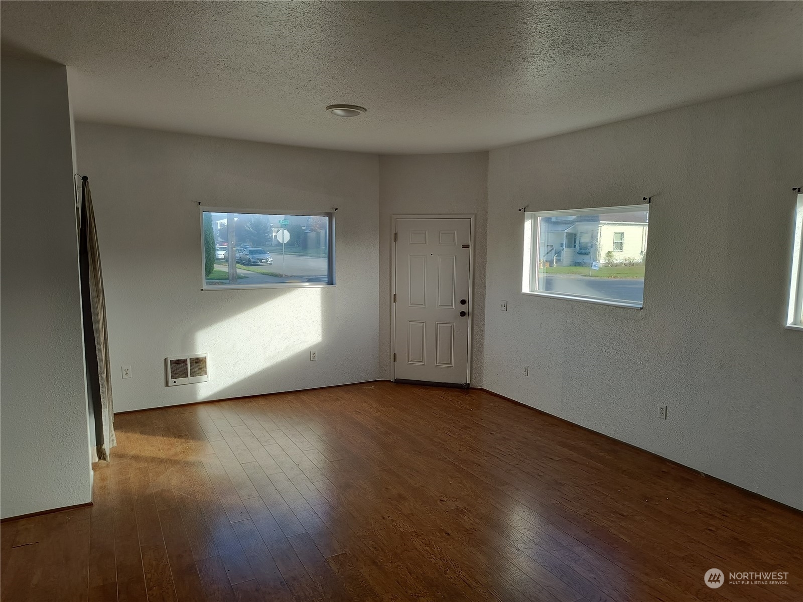 1902 Rockefeller Avenue Everett, WA 98201 - Photo 8 of 17 an empty room with wooden floor and windows