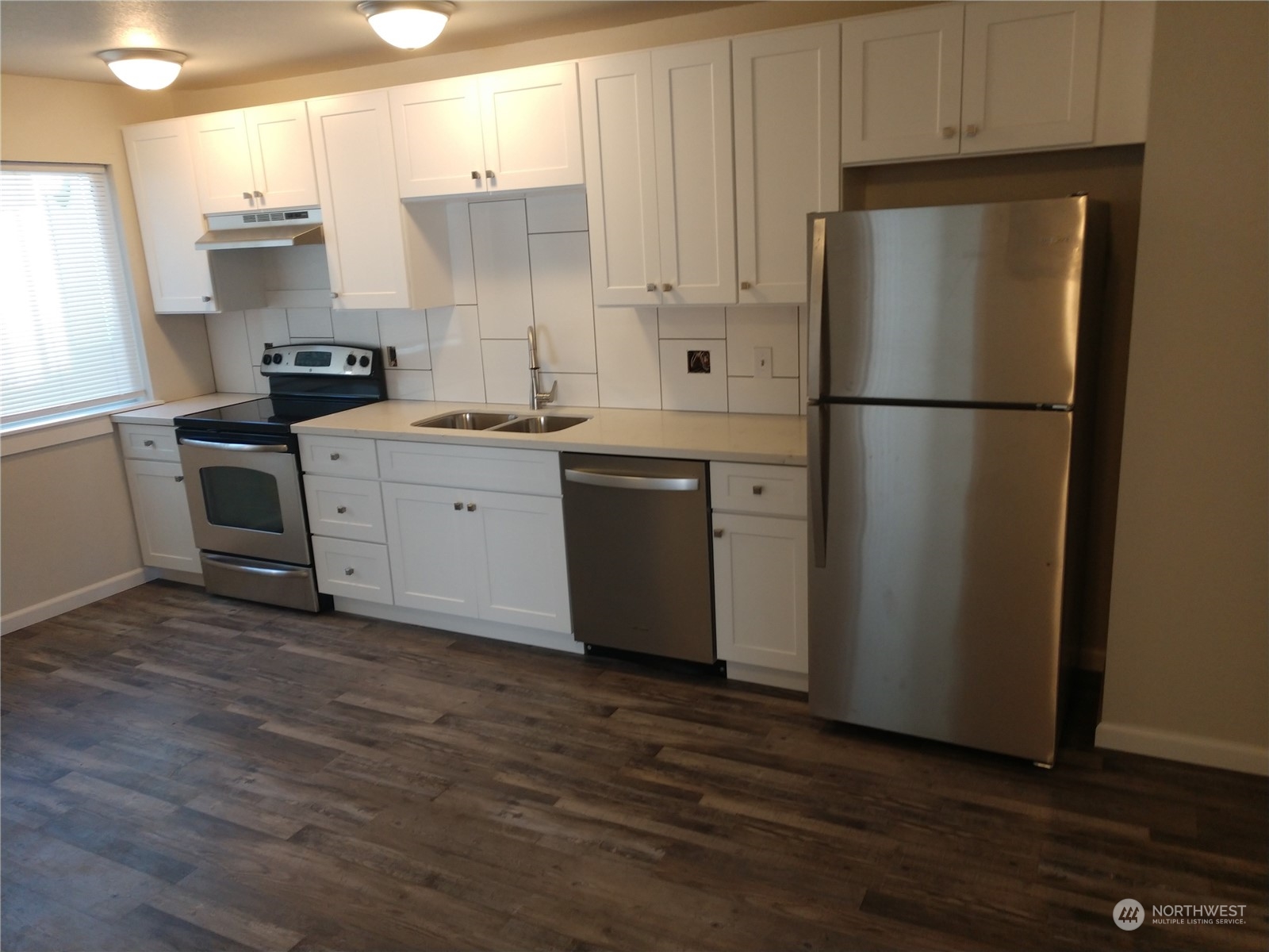 1902 Rockefeller Avenue Everett, WA 98201 - Photo 10 of 17 a kitchen with stainless steel appliances a refrigerator sink and cabinets