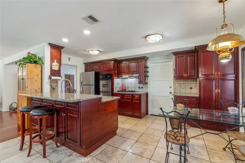 a kitchen with stainless steel appliances granite countertop sink stove and cabinets