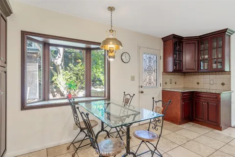 a dining room filled chandelier and wooden floor