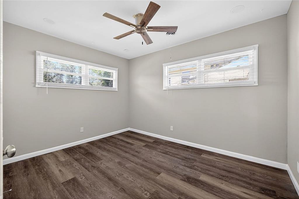 3045 Lindon Lane Decatur, GA 30033 - Photo 15 of 18 a view of a big room with wooden floor and a ceiling fan