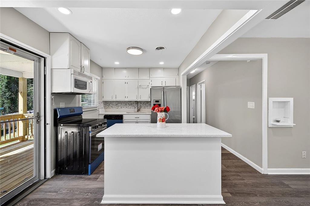 3045 Lindon Lane Decatur, GA 30033 - Photo 9 of 18 a kitchen with kitchen island a sink stainless steel appliances and cabinets