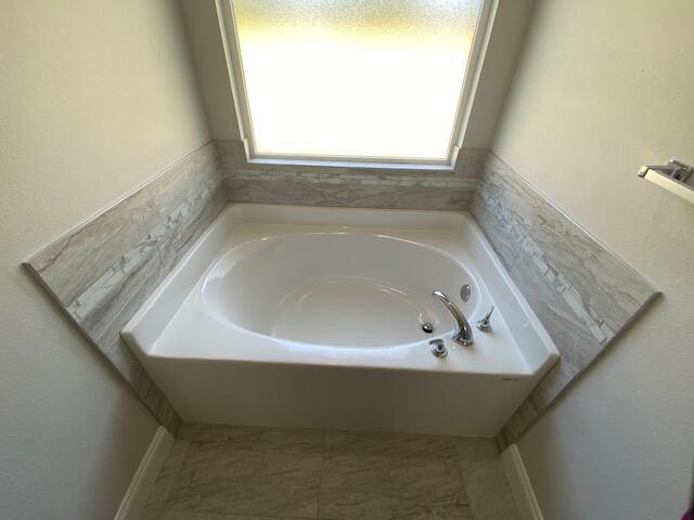 519 Friendship Road Mary Esther, FL 32569 - Photo 26 of 47 a bath tub sitting in a bathroom next to a window
