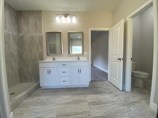 519 Friendship Road Mary Esther, FL 32569 - Photo 29 of 47 a bathroom with a granite countertop sink a toilet a mirror and shower