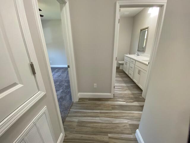 519 Friendship Road Mary Esther, FL 32569 - Photo 36 of 47 a view of a hallway with wooden floor and staircase