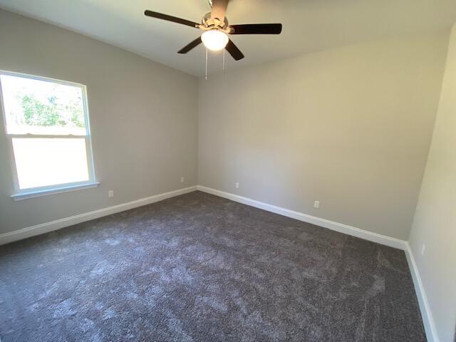 519 Friendship Road Mary Esther, FL 32569 - Photo 45 of 47 an empty room with windows and fan view