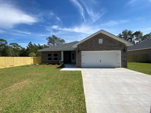 519 Friendship Road Mary Esther, FL 32569 - Photo 47 of 47 a front view of a house with a yard and garage